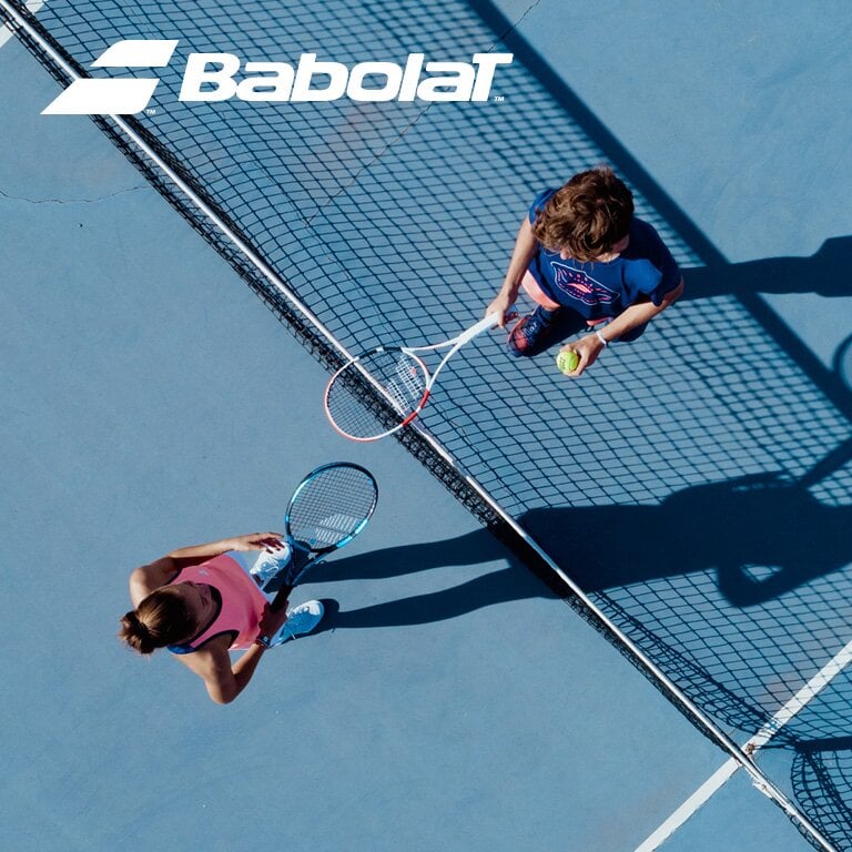 Babolat. Zwei Personen stehen sich auf einem Tennis Platz mit Schlägern in der Hand gegenüber.