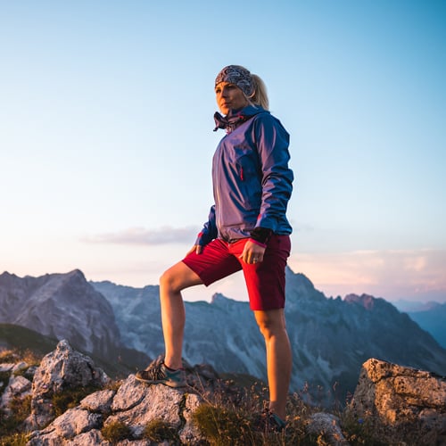 Wanderer steht am felsigen Berg mit schönem Ausblick