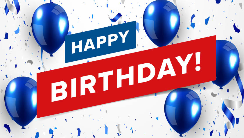  Blaue Luftballons und Konfetti fliegen durch die Luft. Im Vordergrund steht der Schriftzug 'Happy Birthday'